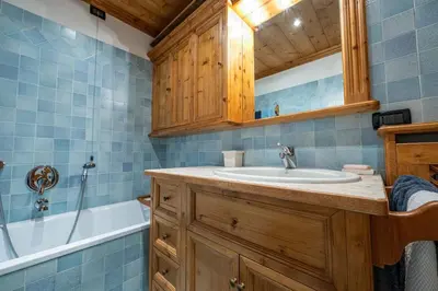 a bathroom with a sink and a tub at Casa Lacedel 1, on ski slopes in Cortina dʼAmpezzo