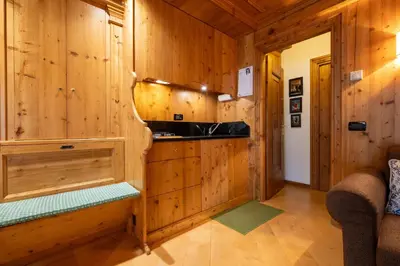 a log cabin bathroom with a sink and wooden walls at Casa Lacedel 1, on ski slopes in Cortina dʼAmpezzo