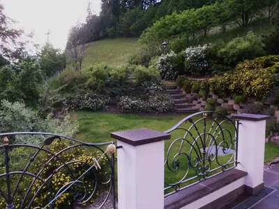 a gate at the entrance to a garden at Appartamenti Valpinoi in Santa Cristina in Val Gardena