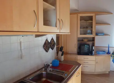 a kitchen with a sink and a microwave at Appartamenti Valpinoi in Santa Cristina in Val Gardena