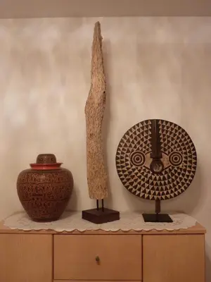 two vases sitting on top of a dresser with a table with a v at Appartamenti Valpinoi in Santa Cristina in Val Gardena