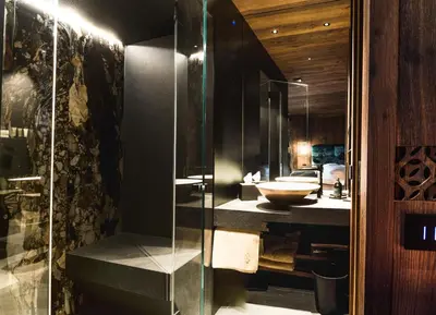 a bathroom with a glass shower and a sink at Chalet Urela Luxury Apartment in Santa Cristina in Val Gardena