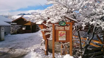 a sign in the snow next to a tree at Vitroler Hof in Rodengo