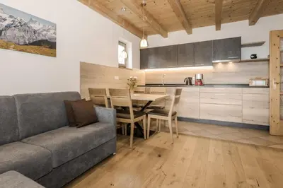 a kitchen and dining room with a couch and a table at Vitroler Hof in Rodengo