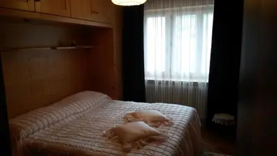 a bedroom with a bed with towels on it at B&B fam. Ausermiller in Castello di Fiemme