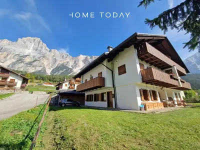 a house with a view of the mountains at HT - Ciasa Dahu Cortina Escape in San Vito di Cadore