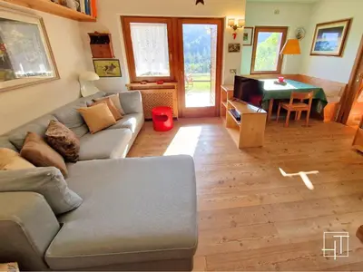 a living room with a couch and a table at HT - Ciasa Dahu Cortina Escape in San Vito di Cadore