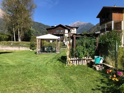 a gazebo in the middle of a grass field at Appartamento Margherita in Transacqua