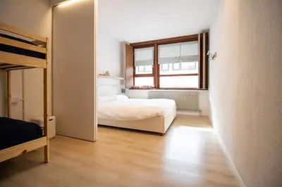 a bedroom with a bed and a window at Casa Franz in Val di Fassa by Zoom In Earth in Mazzin
