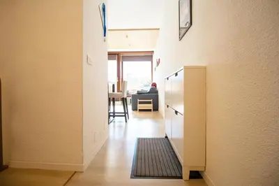 a hallway with a kitchen and a living room at Casa Franz in Val di Fassa by Zoom In Earth in Mazzin