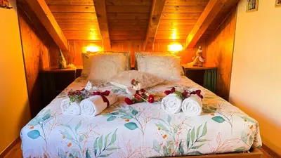 a bed with towels on it in a room at Chalet Stravedo by Ca-Sa Check in Villanova