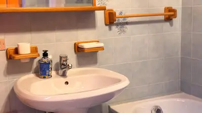 a bathroom with a white sink and a tub at Chalet Stravedo by Ca-Sa Check in Villanova