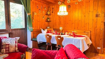 a dining room with a table in a wooden room at Chalet Stravedo by Ca-Sa Check in Villanova