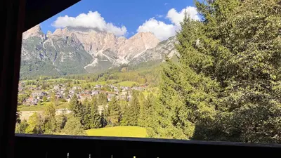 a view of a town in the mountains from a window at Chalet Stravedo by Ca-Sa Check in Villanova