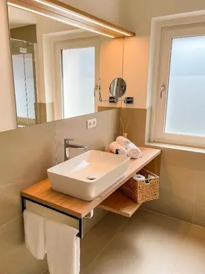 a bathroom with a sink and a mirror at Amontis Dolomites in Siusi