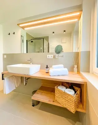 a bathroom with a sink and a mirror at Amontis Dolomites in Siusi