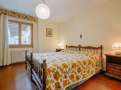 a bedroom with a bed and a wooden cabinet at Apartment Condominio al Parco-11 by Interhome in Canazei