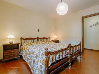 a bedroom with bunk beds and a table and a chair at Apartment Condominio al Parco-11 by Interhome in Canazei