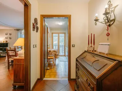 a hallway with a dining room and a living room at Apartment Condominio al Parco-11 by Interhome in Canazei