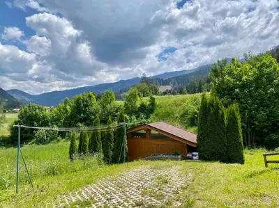 a building in the middle of a field at Zirmo - Your nordic stay in Tesero