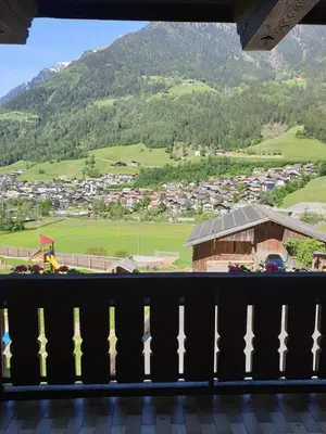 a view from a balcony of a town with a mountain at Pension Gasthof Haselstaude in San Leonardo in Passiria
