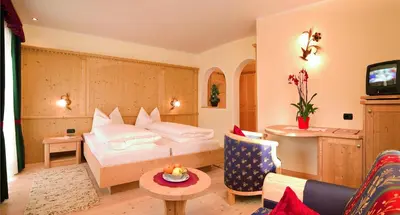 a hotel room with a bed and a couch at Gasthof Gasserhof in Eggen