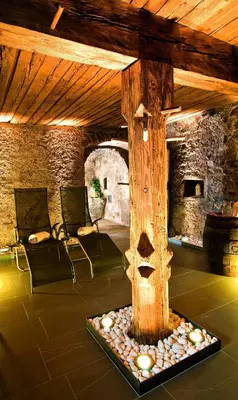 a room with a tree stump in the middle of a room at Gasthof Gasserhof in Eggen
