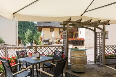 a garden with a bench and a barn at Gasthof Gasserhof in Eggen