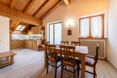 a bedroom with a bed and a desk and a chair at Chalet Al Lago in Masarè