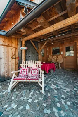a pair of chairs on a patio with a table at Chalet Pian in Campitello di Fassa