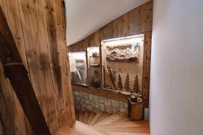a room with a wooden wall with a mirror at Chalet Pian in Campitello di Fassa