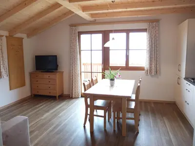 a kitchen and dining room with a table and chairs at Haus Schlernblick in Nova Ponente