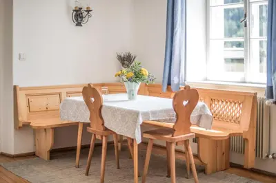 a dining room with a table and two chairs at Rieplhof - Relaxing farm stay with breakfast and mountain view in Vipiteno