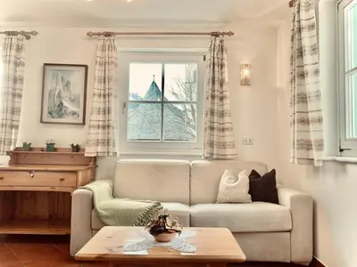 a living room with a couch and a window at Cesa Cascata in Canazei