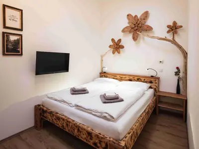 a bedroom with a bed with a flat screen tv at Luxury Larch Loft in Tesido