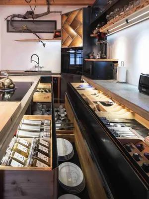 a kitchen with a counter with many dishes in it at Luxury Larch Loft in Tesido