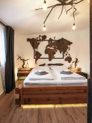 a bedroom with a large bed with a wooden frame at Luxury Larch Loft in Tesido