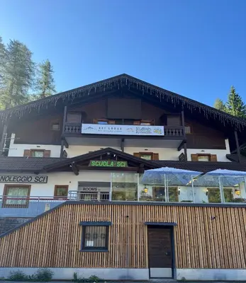 a building with a restaurant in front of it at Ski Lodge Pampeago in Tesero