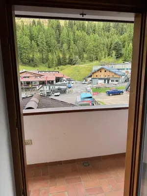 a window with a view of a train yard at Ski Lodge Pampeago in Tesero