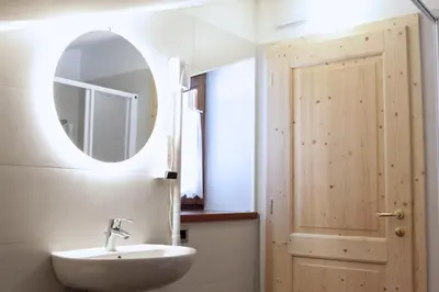 a bathroom with a sink and a mirror at Ski Lodge Pampeago in Tesero
