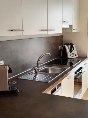 a kitchen with a sink and a counter top at Apartment 66 - Modernes Apartment mit Balkon und Parkplatz in Toplage in Brixen in Bressanone