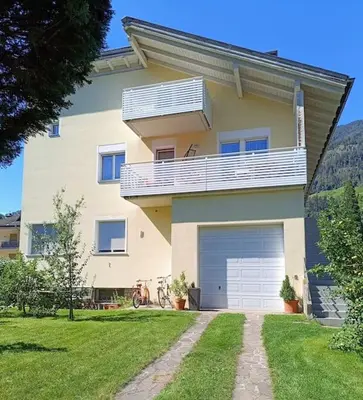 a large house with a balcony and a garage at Apartment 66 - Modernes Apartment mit Balkon und Parkplatz in Toplage in Brixen in Bressanone
