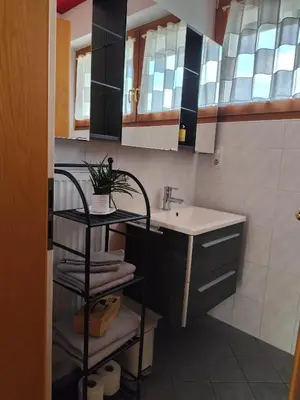 a small bathroom with a sink and a sink at Apartment 66 - Modernes Apartment mit Balkon und Parkplatz in Toplage in Brixen in Bressanone