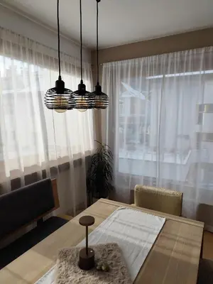 a dining room with a table and a large window at Apartment 66 - Modernes Apartment mit Balkon und Parkplatz in Toplage in Brixen in Bressanone