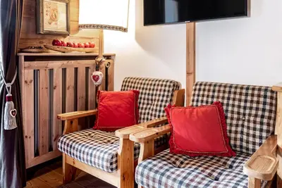 two chairs with red pillows in a room at Chalet Sassongher II in Corvara in Badia