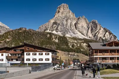 a view of a mountain with a street and buildings at Chalet Sassongher II in Corvara in Badia