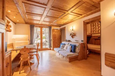 a living room with a couch and a table at Casa Lacedel 2, on ski slopes in Cortina dʼAmpezzo
