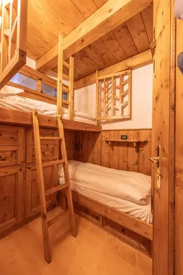 a bunk bed room with two bunk beds in a cabin at Casa Lacedel 2, on ski slopes in Cortina dʼAmpezzo