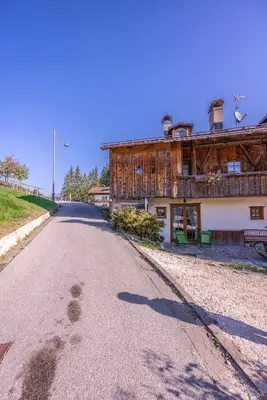 an empty road in front of a building at Casa Lacedel 2, on ski slopes in Cortina dʼAmpezzo
