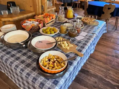 a table with a blue table cloth with food on it at Agriturismo Busa dei Sbrase in San Cipriano